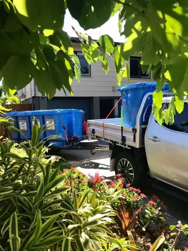 Blondies Bins truck pulling a trailer of garden bins